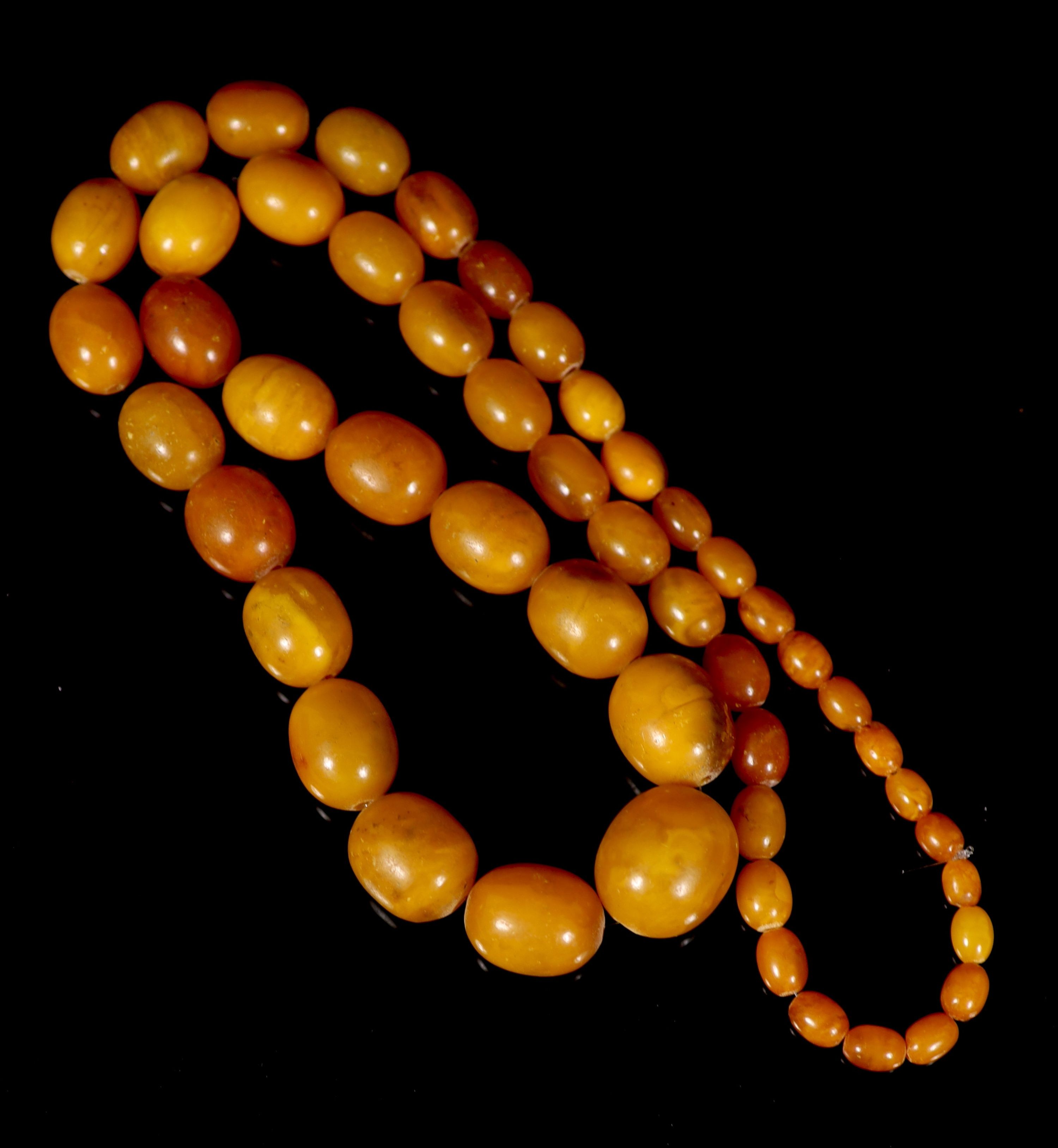 A single strand graduated oval amber bead necklace, 84cm, gross weight 118 grams.